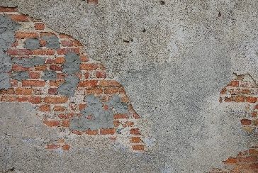 Brick wall with crumbling stucco