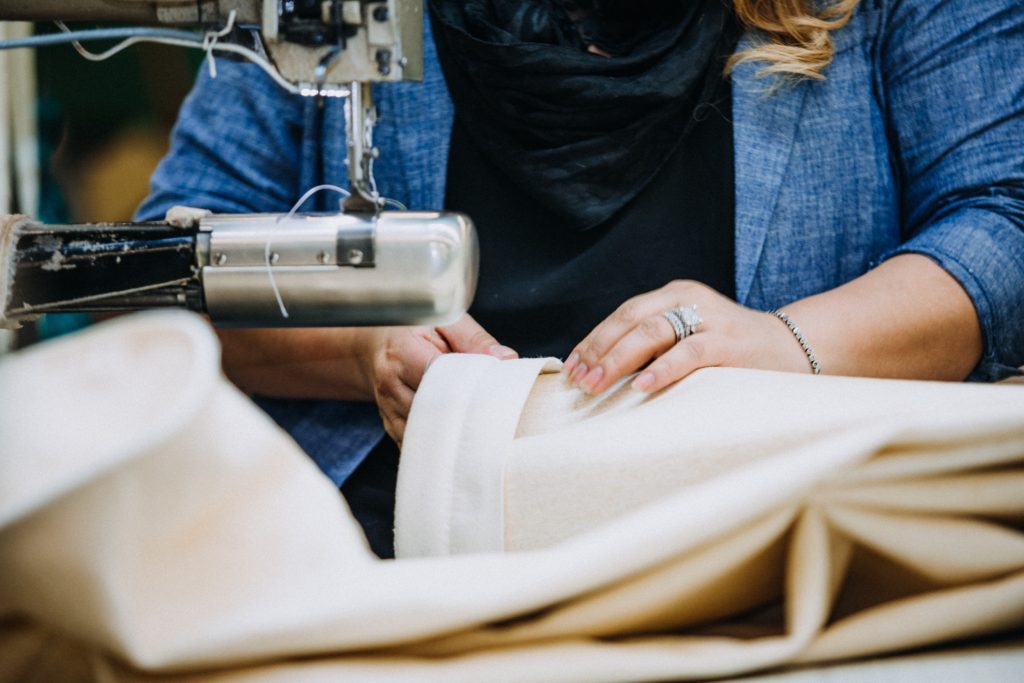 Person sewing on a sewing machine