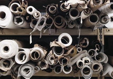 Rolls of woven felted fabric